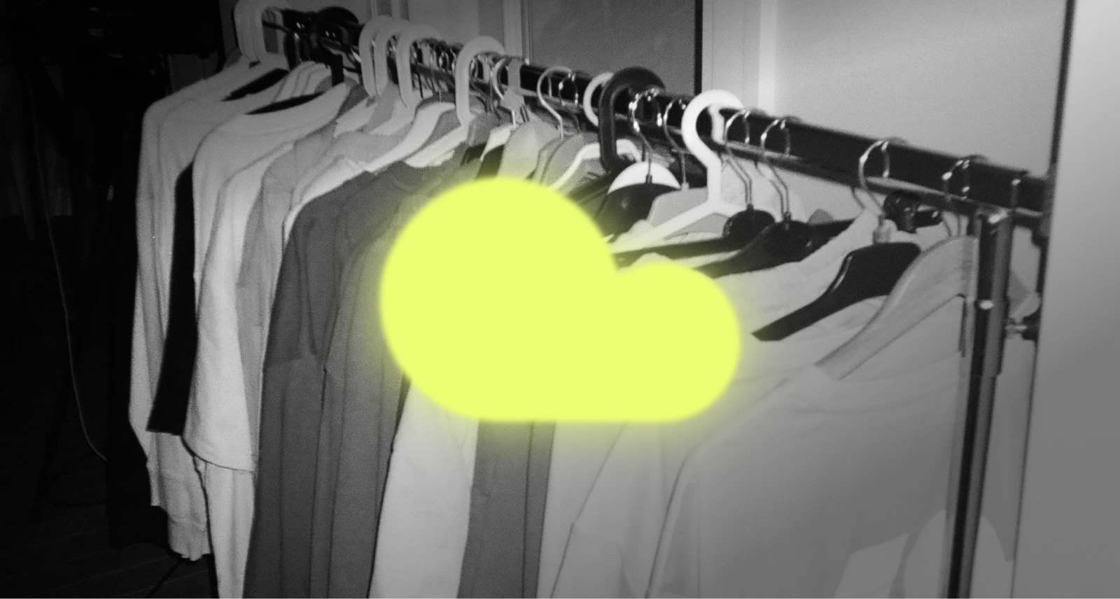 Grafika wizerunkowa prezentująca kolekcję odzieży Kubota na wieszakach podczas Black Weeks. Czarno-białe zdjęcie z kontrastowym, neonowym elementem w kształcie chmury, będącym częścią logo Kubota.